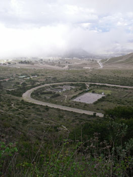 Horse racing track near Calacali with a cloudy Quito in the background