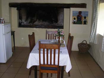 Dining kitchen at the Cottage B&B De Hoop and scene of roaring fire.